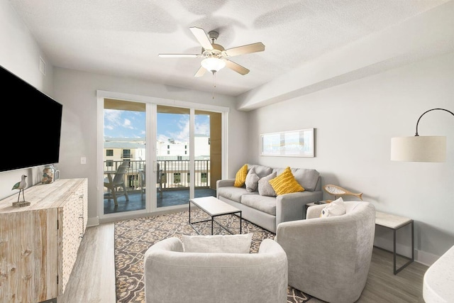 15928 Front Beach Rd Unit 3-409, Panama City Beach, FL 32413 - living area featuring baseboards, ceiling fan, a textured ceiling, and wood finished floors