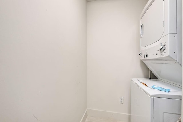 15928 Front Beach Rd Unit 3-409, Panama City Beach, FL 32413 - laundry area with baseboards, stacked washer and clothes dryer, and laundry area