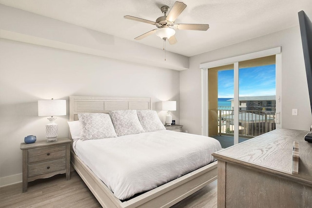 bedroom featuring hardwood / wood-style floors, access to exterior, and ceiling fan