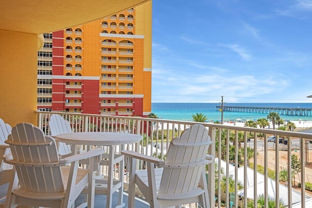 balcony with a water view and a beach view