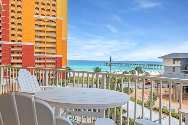 balcony featuring a view of the beach and a water view