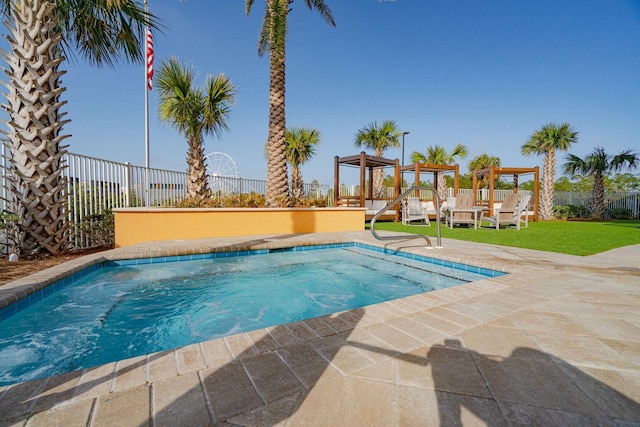 view of swimming pool featuring a patio area and a yard