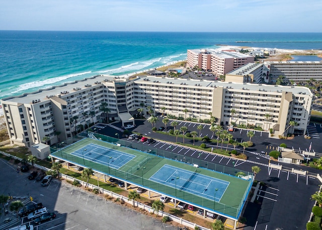 drone / aerial view featuring a water view and a beach view