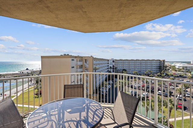 balcony featuring a water view and a view of the beach