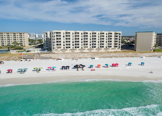 bird's eye view featuring a water view and a beach view