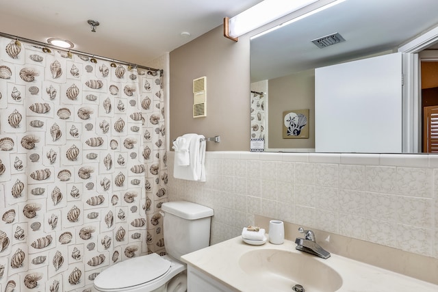 bathroom with vanity, toilet, tile walls, and curtained shower