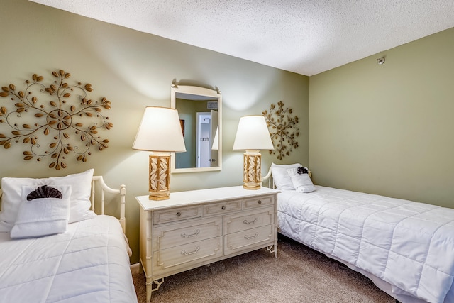 bedroom featuring a textured ceiling and carpet flooring