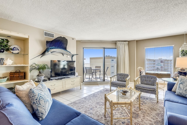 tiled living room featuring a textured ceiling and a healthy amount of sunlight