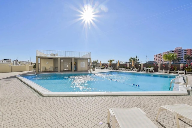 view of swimming pool featuring a patio area