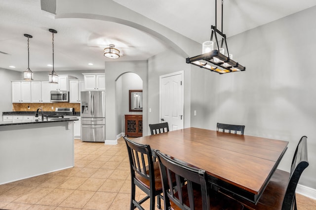 dining space with sink and light tile patterned floors