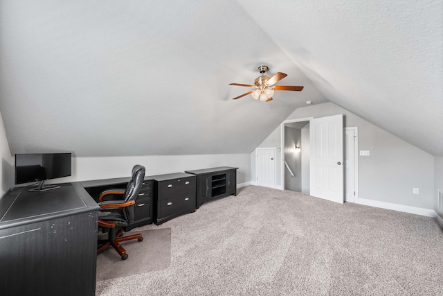 carpeted office space with ceiling fan, a textured ceiling, and lofted ceiling