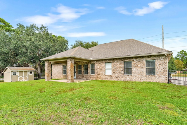 rear view of property with a patio, a storage shed, and a lawn