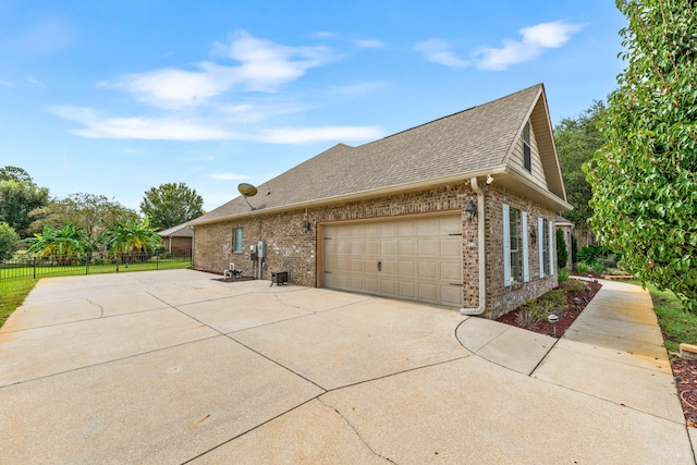 view of side of home featuring a garage