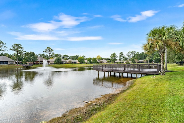 dock area featuring a yard and a water view