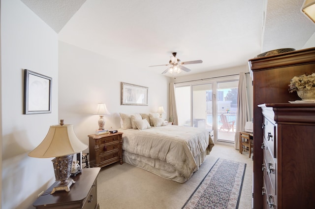 bedroom with ceiling fan, access to outside, a textured ceiling, and light colored carpet