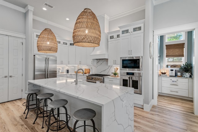 88 Beth Ln, Santa Rosa Beach, FL 32459 - kitchen featuring visible vents, built in appliances, custom range hood, decorative backsplash, and white cabinetry