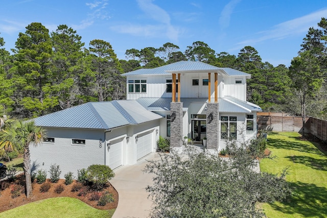 88 Beth Ln, Santa Rosa Beach, FL 32459 - view of front facade featuring board and batten siding, concrete driveway, a front yard, metal roof, and a garage