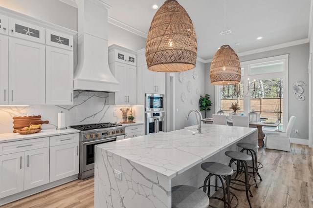 88 Beth Ln, Santa Rosa Beach, FL 32459 - kitchen featuring premium range hood, ornamental molding, a sink, white cabinets, and appliances with stainless steel finishes