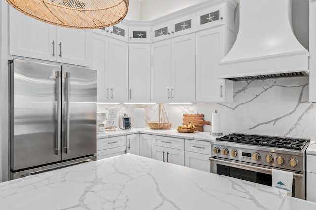88 Beth Ln, Santa Rosa Beach, FL 32459 - kitchen featuring tasteful backsplash, glass insert cabinets, custom range hood, premium appliances, and white cabinets