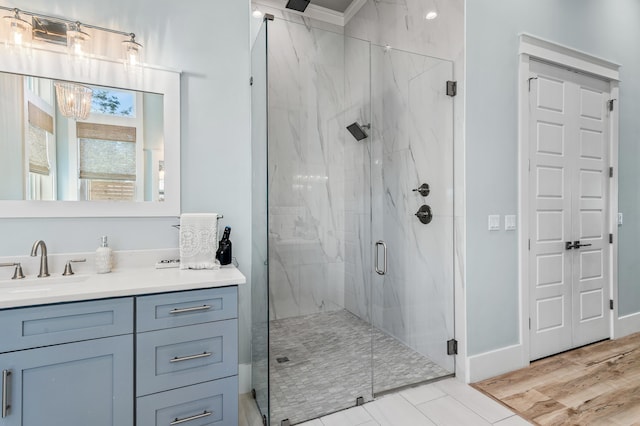 88 Beth Ln, Santa Rosa Beach, FL 32459 - full bath featuring vanity, wood finished floors, baseboards, and a marble finish shower