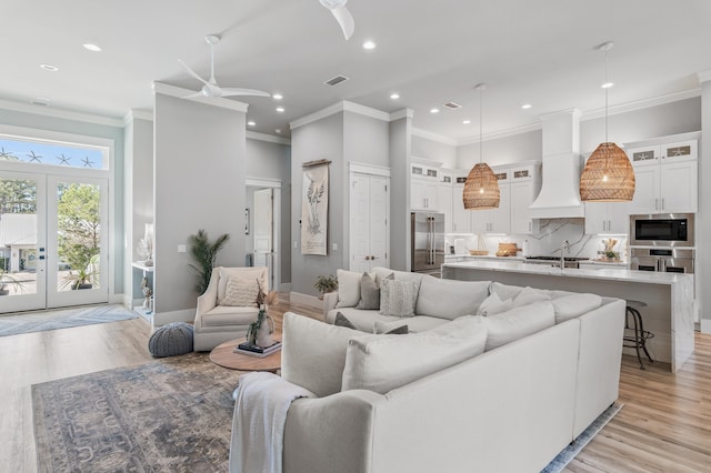 88 Beth Ln, Santa Rosa Beach, FL 32459 - living room with baseboards, light wood-style flooring, a ceiling fan, and ornamental molding