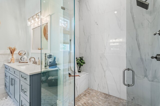 88 Beth Ln, Santa Rosa Beach, FL 32459 - bathroom featuring a marble finish shower, tile walls, and vanity