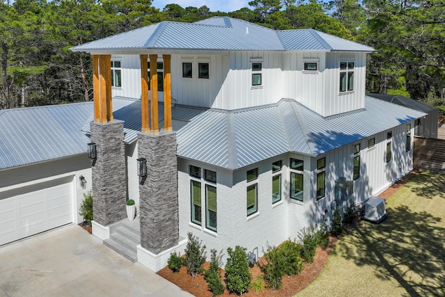 88 Beth Ln, Santa Rosa Beach, FL 32459 - view of front of home with central AC unit, board and batten siding, driveway, and metal roof
