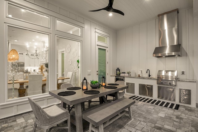 88 Beth Ln, Santa Rosa Beach, FL 32459 - dining area featuring brick floor, ceiling fan with notable chandelier, and a decorative wall