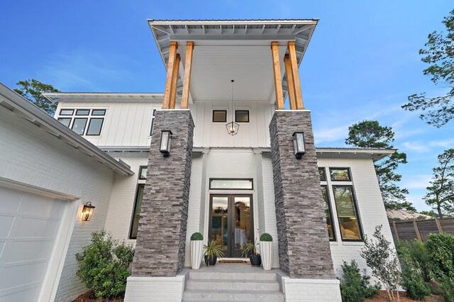 88 Beth Ln, Santa Rosa Beach, FL 32459 - entrance to property featuring french doors, brick siding, and metal roof