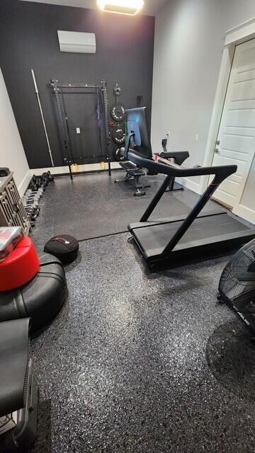 88 Beth Ln, Santa Rosa Beach, FL 32459 - workout room featuring baseboards and a wall mounted AC