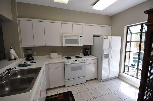 kitchen with sink, white cabinetry, white appliances, and plenty of natural light