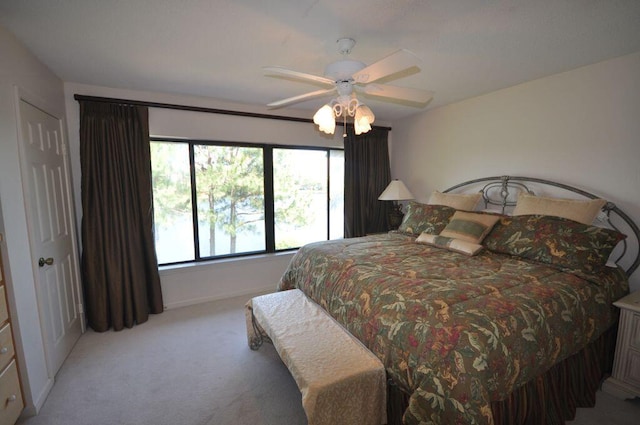 bedroom with light colored carpet and ceiling fan