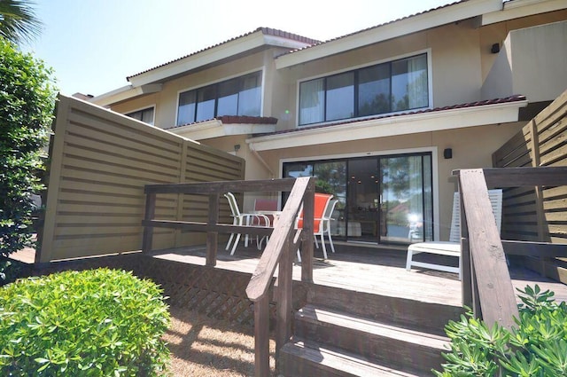 back of property with a wooden deck