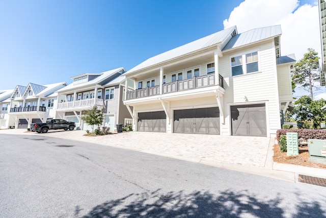 multi unit property with a balcony and a garage