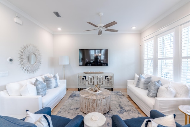 living room featuring crown molding, light hardwood / wood-style floors, and ceiling fan