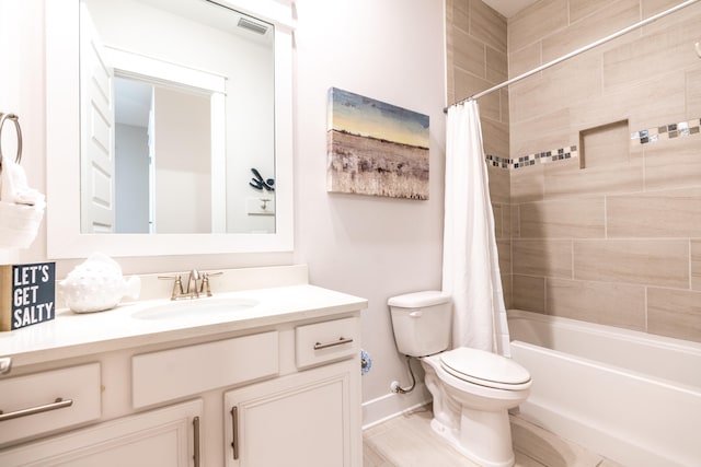 full bathroom with vanity, toilet, and shower / tub combo