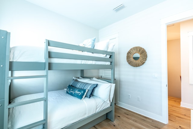 bedroom with wood-type flooring