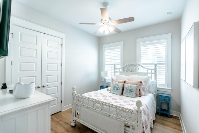 bedroom featuring a closet, light hardwood / wood-style floors, and ceiling fan