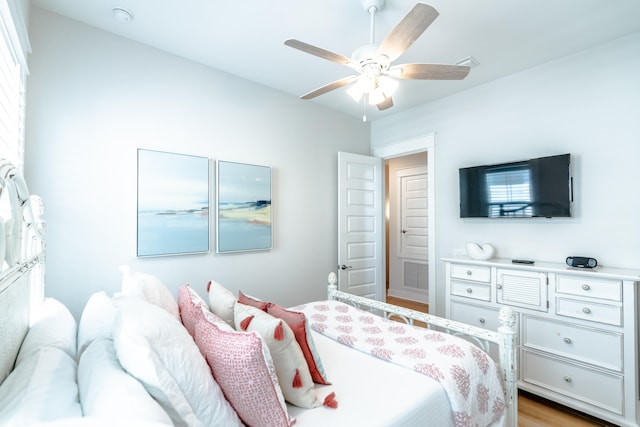 bedroom with ceiling fan and light hardwood / wood-style flooring