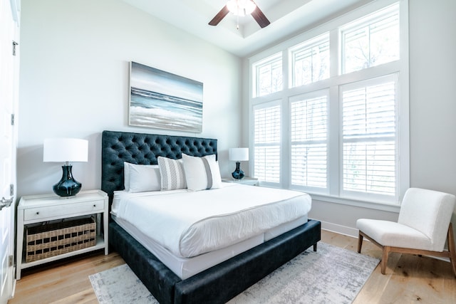 bedroom with ceiling fan and light hardwood / wood-style flooring