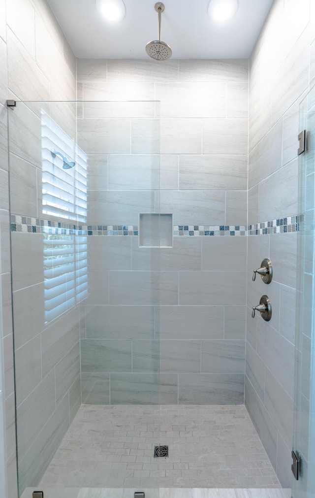 bathroom with a shower with door