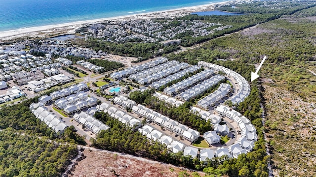 aerial view with a water view and a beach view