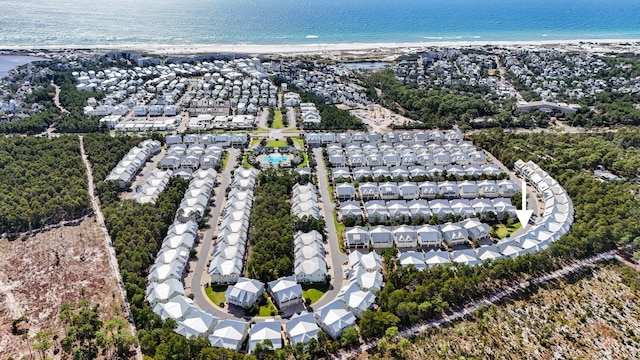 bird's eye view featuring a water view and a beach view