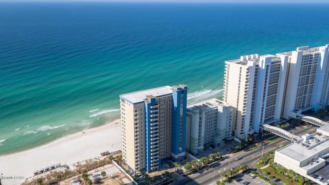 bird's eye view with a water view and a beach view