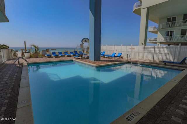 view of pool featuring a water view