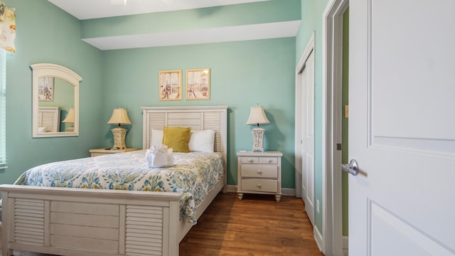 bedroom with dark hardwood / wood-style flooring