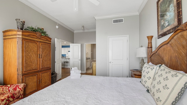 bedroom featuring ceiling fan, ornamental molding, ensuite bath, and hardwood / wood-style floors