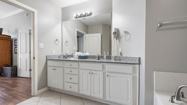 bathroom with vanity, wood-type flooring, and ornamental molding