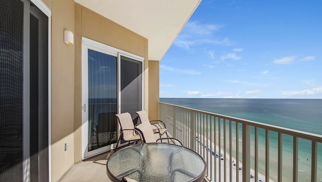 balcony with a water view and a beach view