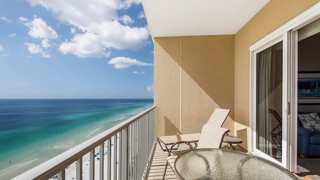 balcony featuring a water view and a beach view